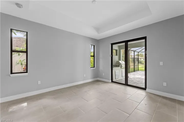 Spare room with light tile floors and a raised ceiling