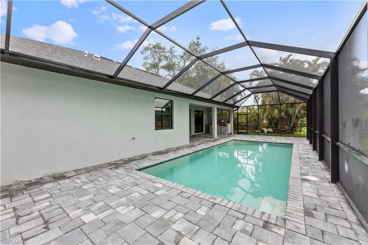 View of pool featuring a patio and a lanai
