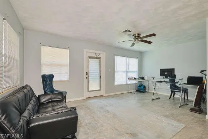 Living area featuring an office area and ceiling fan