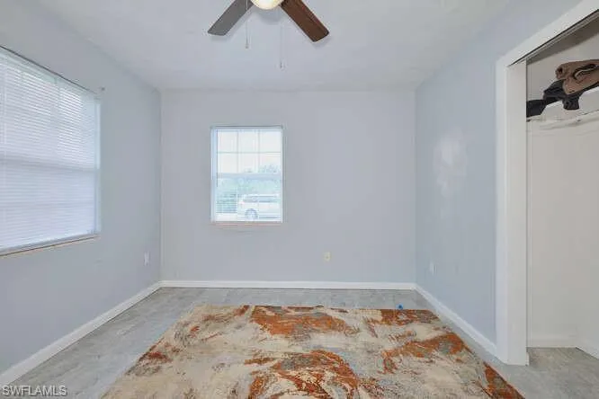 Unfurnished room featuring baseboards and ceiling fan
