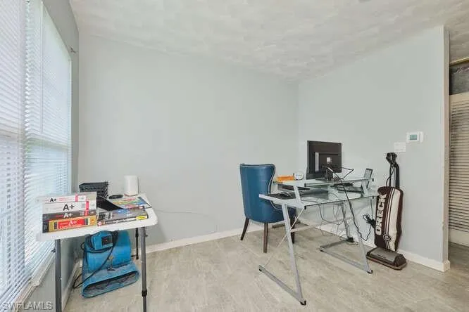 Office area featuring healthy amount of natural light and light wood finished floors