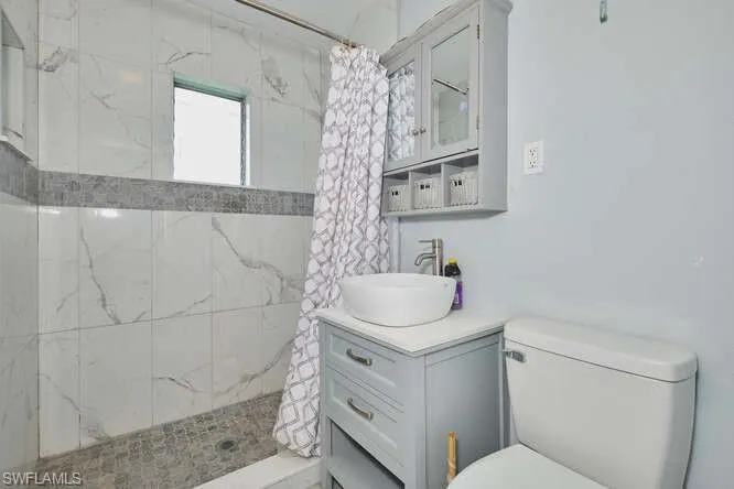 Bathroom with a stall shower and vanity