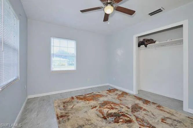 Unfurnished bedroom with a closet and ceiling fan