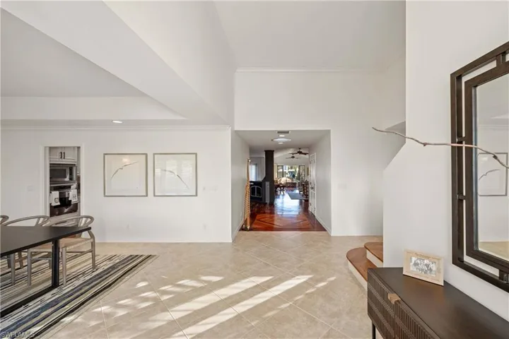 Tiled foyer featuring crown molding