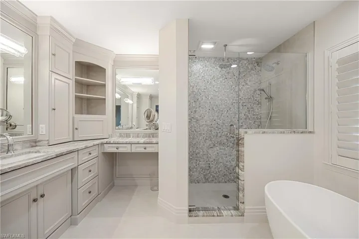 Bathroom featuring tile patterned floors, vanity, and independent shower and bath