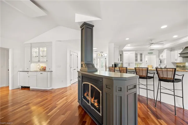 Kitchen with white cabinets, wood-type flooring, and ceiling fan