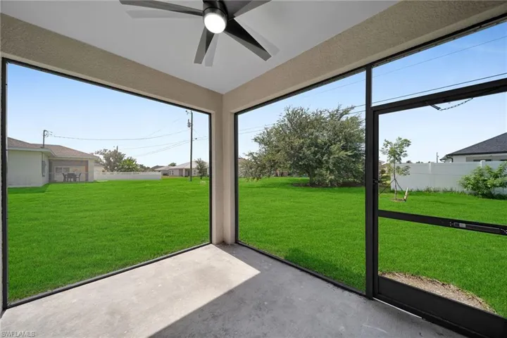 Unfurnished sunroom with ceiling fan