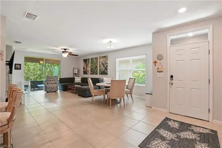 Kitchen with stainless steel appliances, open floor plan, dark brown cabinets, breakfast bar