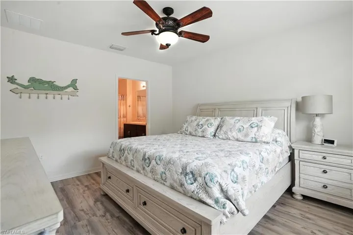 Bedroom featuring walk-in closet and ensuite bath
