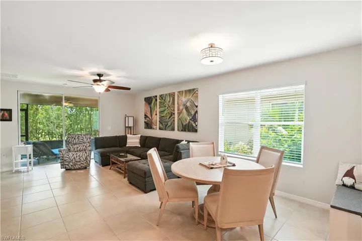 Living area featuring ceiling fan and light tile patterned floors