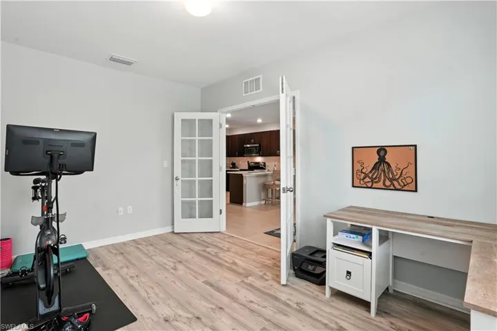 Den/Office bonus room featuring french doors and vinyl plank flooring