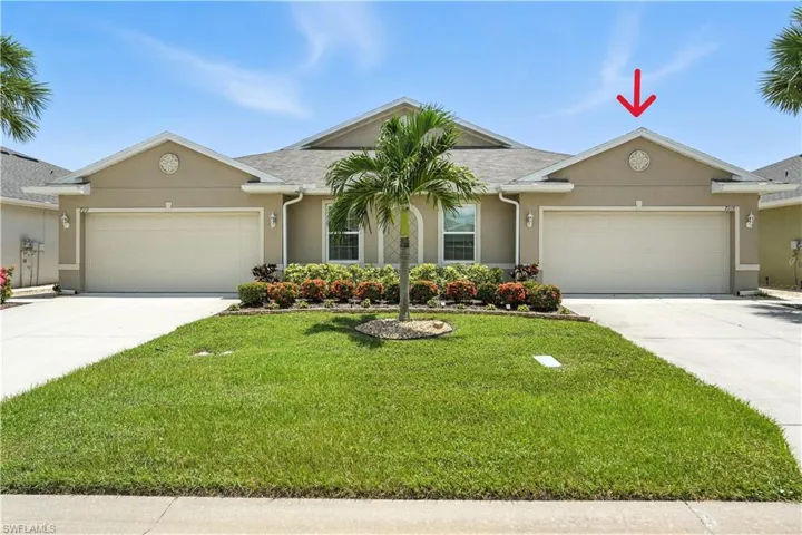 Ranch-style villa with  attached garage, and concrete driveway