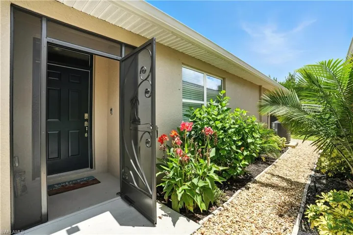 Property entrance featuring covered screened entrance