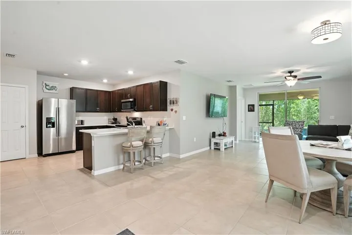 Dining space featuring light tile patterned floors and ceiling fan