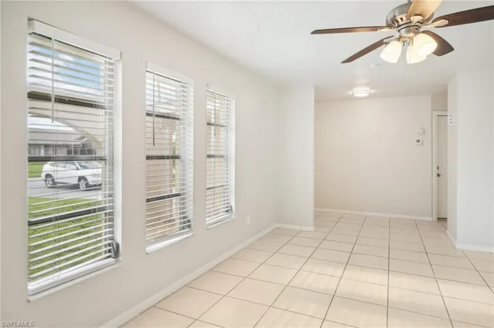 Spare room with light tile patterned floors and ceiling fan