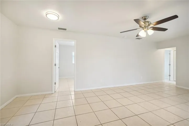 Spare room with light tile patterned floors and ceiling fan