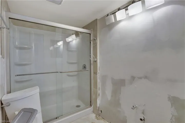 Bathroom featuring walk in shower and toilet