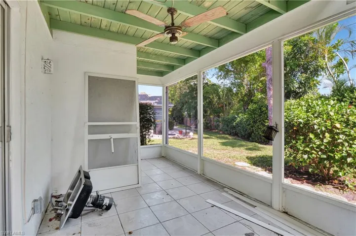 Unfurnished sunroom with beam ceiling, wood ceiling, and ceiling fan