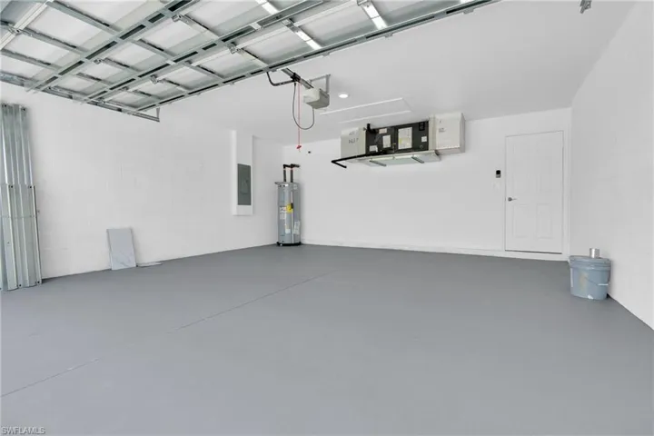 Spacious garage with a gray-finished floor and white painted walls