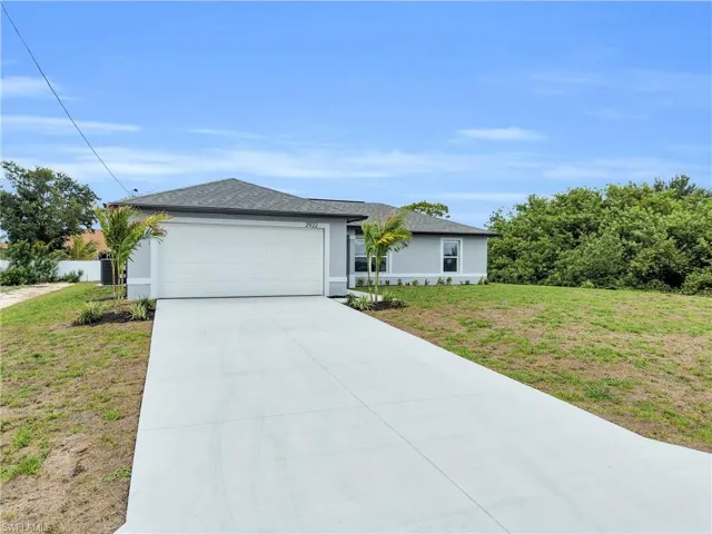 Contemporary single-story residence featuring a two-car garage, concrete driveway, and a shingle roof