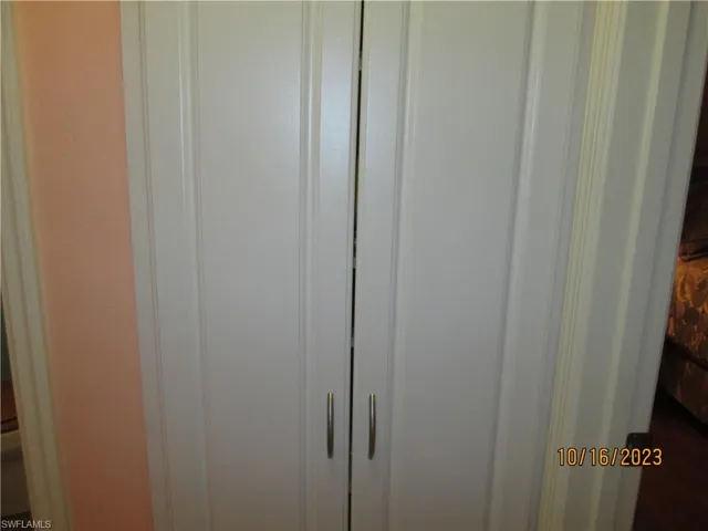 Spacious linen cabinet in hallway.