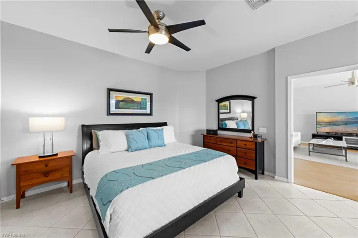 Bedroom featuring light tile patterned floors and ceiling fan