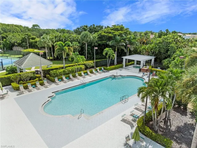 Community pool with a patio area and a pergola