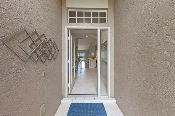 View of exterior entry featuring stucco siding