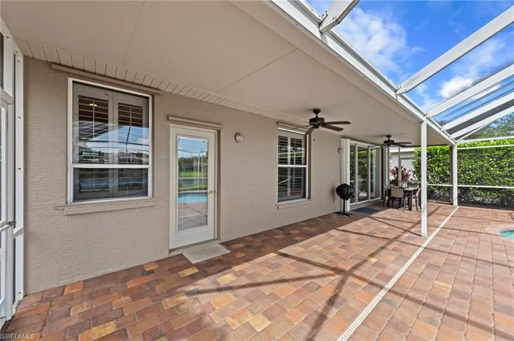 View of patio / terrace featuring a sunroom, glass enclosure, and a ceiling fan