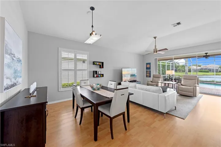 Dining area featuring light wood-style floors and ceiling fan