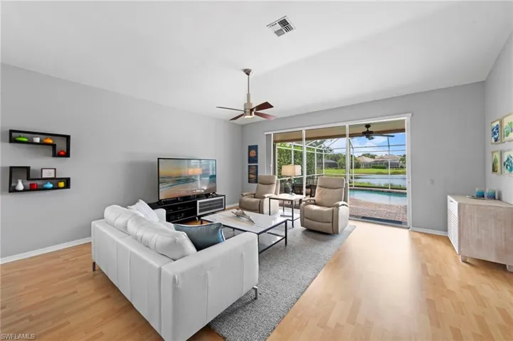 Living room featuring light wood finished floors and a ceiling fan