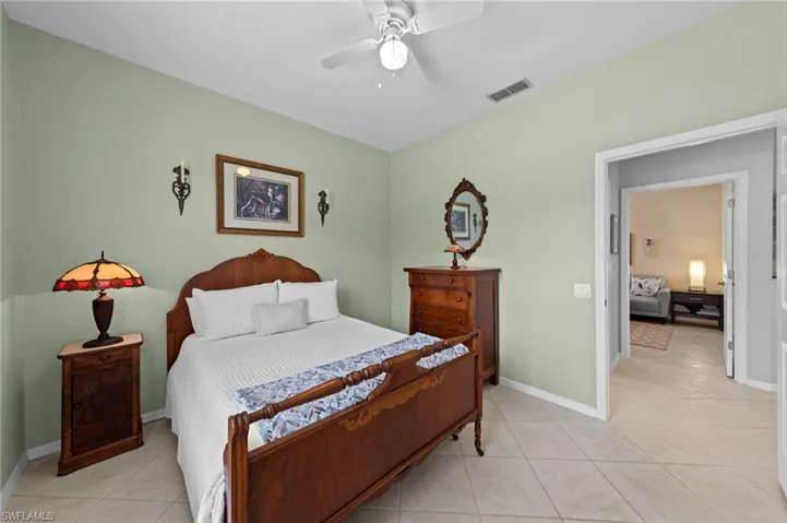 Bedroom with light tile patterned flooring and a ceiling fan
