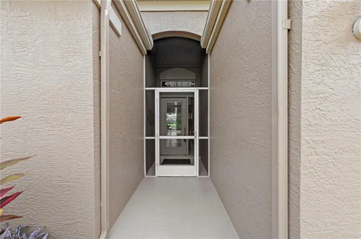 Doorway to property with stucco siding