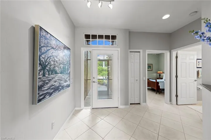 Foyer entrance featuring light tile patterned flooring