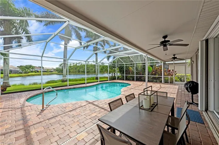Swimming pool with a sunroom, a patio area, and a lanai