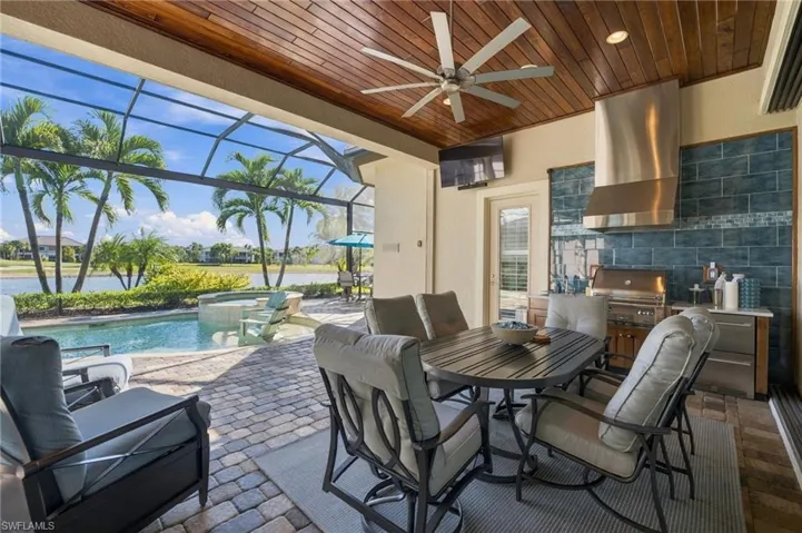 Covered lanai featuring a wood-plank ceiling, recessed lighting, and a ceiling fan