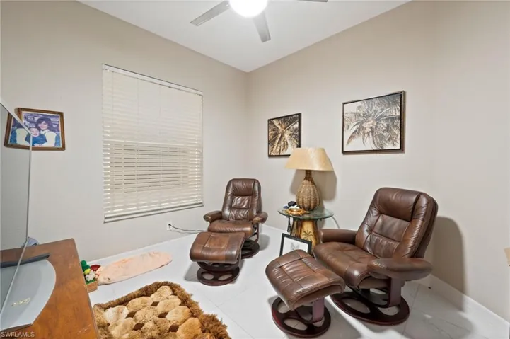 Sitting room featuring tile patterned floors and ceiling fan