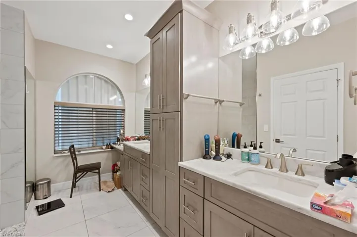 Bathroom featuring tile patterned flooring and vanity