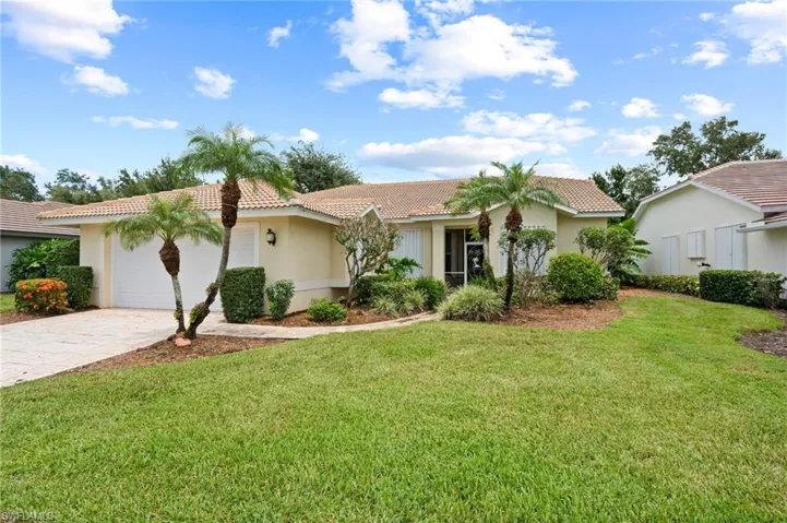Mediterranean / spanish-style home featuring a garage and a front yard
