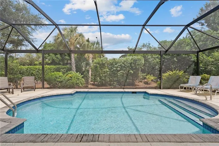 View of pool with a patio and a lanai