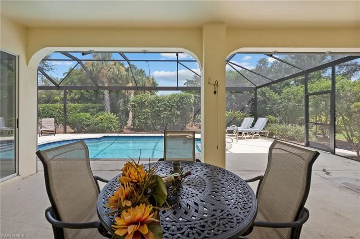 View of pool with a patio area and a lanai