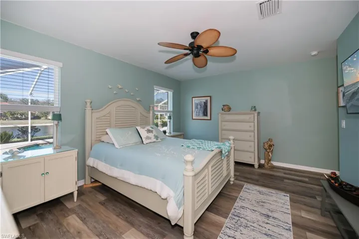 Bedroom featuring ceiling fan and dark wood-type flooring