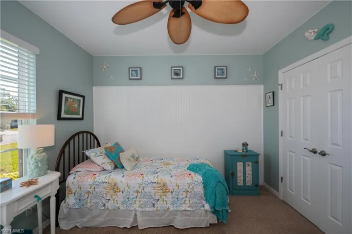 Carpeted bedroom with ceiling fan