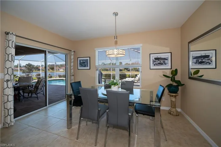 Dining space with light tile patterned floors