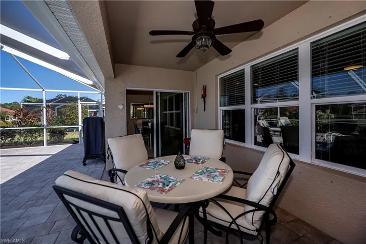 View of patio featuring a lanai and ceiling fan
