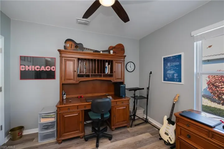 Office with ceiling fan and light hardwood / wood-style flooring