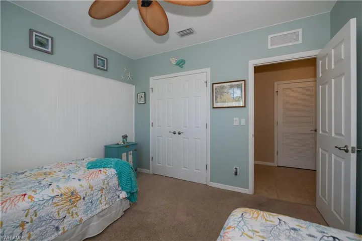 Bedroom featuring carpet flooring, ceiling fan, and a closet
