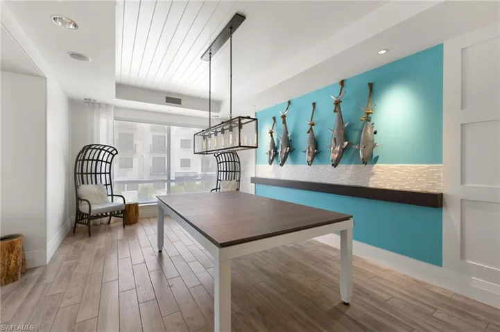 Dining room with light wood-style flooring and a raised ceiling