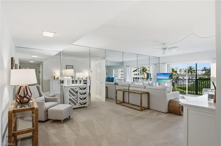 Light and bright open floor plan with 2 bedrooms, 2 bathrooms, hurricane impact windows, storm shutters, A COVERED PARKING SPACE