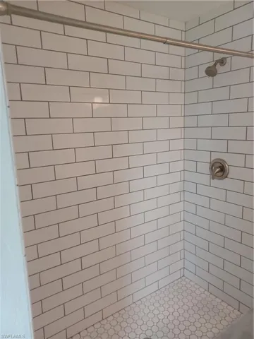 Full bath featuring a shower stall